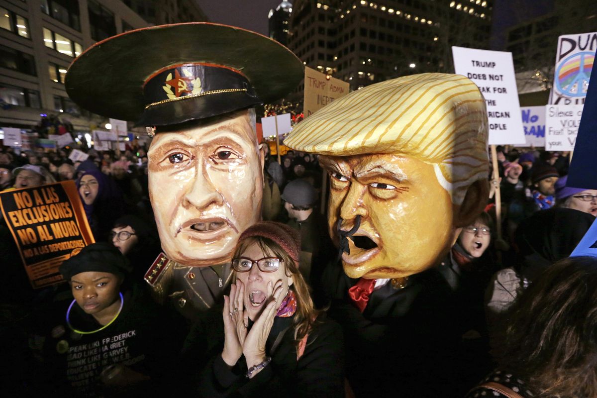 A woman shouts out as she stands in front of effigies portraying Russia’s President Vladimir Putin and United States President Donald Trump at rally to oppose Trump’s executive order banning travel to the United States by citizens of seven countries Sunday, Jan. 29, 2017, in downtown Seattle. (Elaine Thompson / Associated Press)