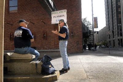 
Steelworkers Glenn Smith, left, and Kim Smith, no relation, talk shop Monday outside the Hotel Lusso in support of union members employed by Potlatch. The USW delegation congregated outside the Potlatch annual meeting in downtown Spokane.
 (Brian Plonka / The Spokesman-Review)