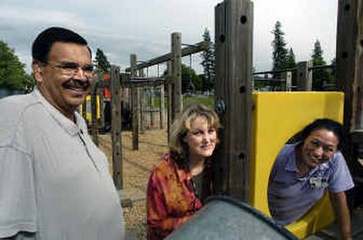 
Sheridan Elementary Principal Don Warner, left, PTA member Sheila Mulligan, center, and PTA Vice President Rachel Socha stand Tuesday in the old playground equipment they are trying to replace. The PTA has started a fund-raising campaign to get new equipment for the school. Their goal is $58,000  and  Friday they will hold an auction to help meet that total. 
 (Christopher Anderson/ / The Spokesman-Review)