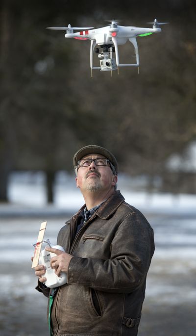 Spokesman-Review photographer Jesse Tinsley steadies his helicopter, carrying a tiny camera, in a park Thursday on Spokane’s South Hill. A video he shot with this craft and put up at spokesman.com caught the attention of a media blogger, who alerted the FAA. The agency has ruled that drones may not be used for commercial purposes. The FAA has pledged to create rules for their use, but that could be months or years away. (Dan Pelle)
