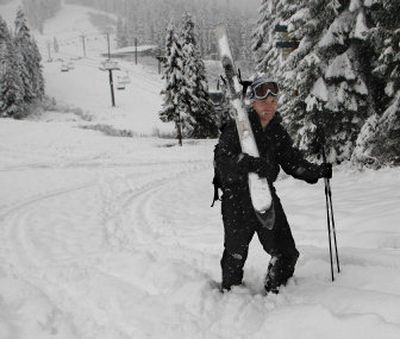 
Orion Watson of Burien walks back up at the Stevens Pass ski area while skiing in snow 12 to 18 inches deep on Tuesday. 
 (Associated Press / The Spokesman-Review)