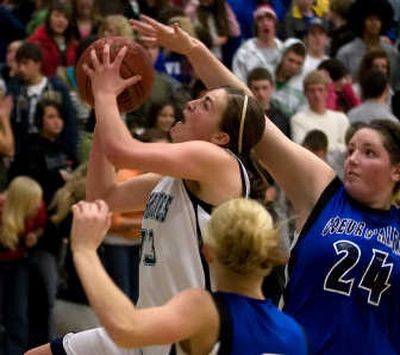 
Lake City's Katie Baker puts up a shot under the basket as Coeur d'Alene's Carli Rosenthol (24) attempts to block.The Spokesman Review
 (BRUCE TWITCHELL The Spokesman Review / The Spokesman-Review)
