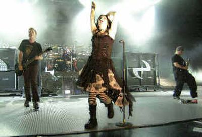 
Singer Amy Lee, center, of the music group Evanescence performs during a concert with the band at Universal Amphitheater in Los Angeles in August 2003. 
 (File/Associated Press / The Spokesman-Review)