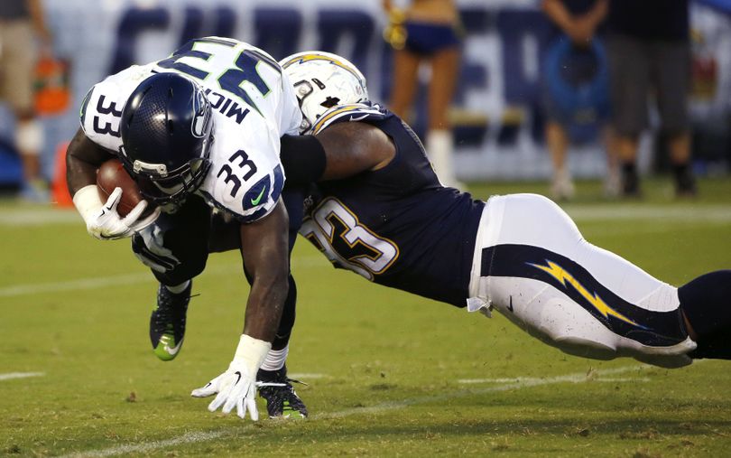 Seahawks running back Christine Michael is brought down by Darius Philon. (Associated Press)