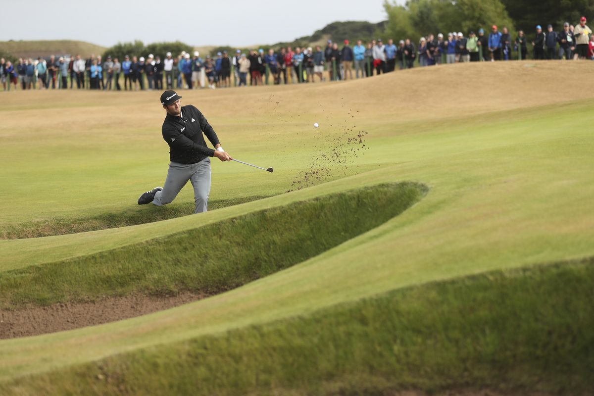 Jon Rahm  plays out of a bunker on the sixth hole during the second round of the British Open  in Carnoustie, Scotland, on Friday. (Peter Morrison / AP)