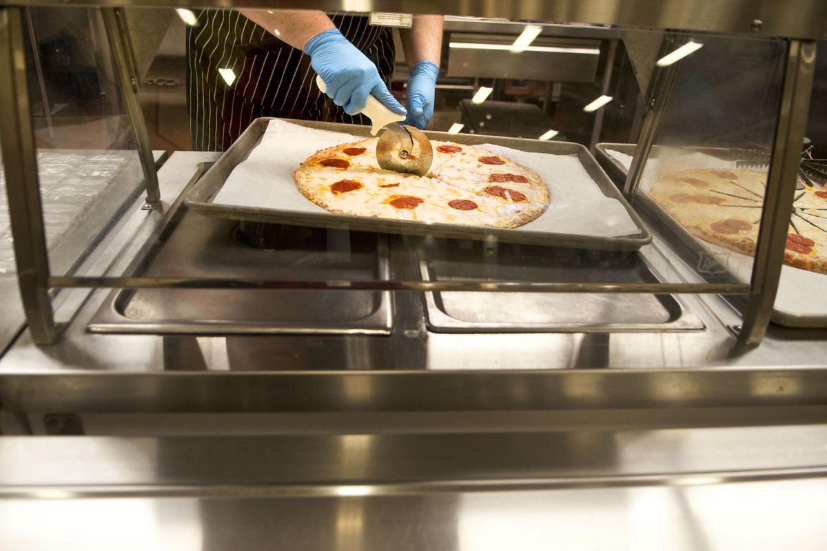 Fresh made pizza in sliced at Jefferson Elementary in Spokane on Thursday, Nov. 8, 2018. Jefferson is one of the area schools that are now batch cooking, in which all meals are prepared from scratch in the kitchen. (Kathy Plonka / The Spokesman-Review)