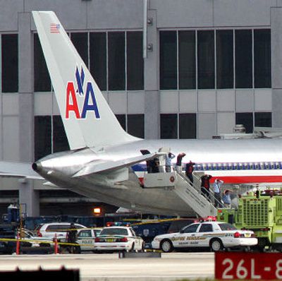 
Passengers exit an American Airlines jet in Miami after a passenger who claimed to have a bomb was shot and killed by a federal air marshal Wednesday.
 (Associated Press / The Spokesman-Review)