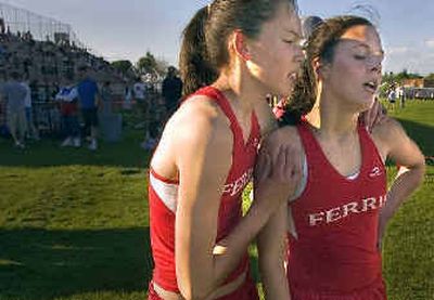 
Kelli McNamee (left) holds onto the shoulders of Ferris teammate Ali Spear after they finished 1-2 in the 300 hurdles. Spear won in 47.2 with McNamee second at 47.8.
 (Christopher Anderson/ / The Spokesman-Review)