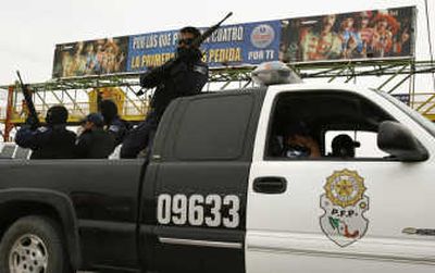 
Mexican federal police patrol the streets of Reynosa, Tamaulipas,  on Wednesday in the wake of violent confrontations between authorities and alleged drug traffickers that left five dead. 
 (Associated Press / The Spokesman-Review)