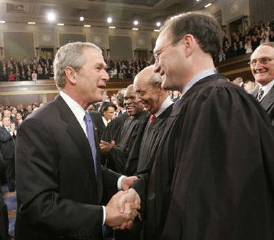 
President Bush greets newly appointed Supreme Court Justice Samuel Alito as he makes his way into the House chamber to deliver his annual State of the Union speech Tuesday before a joint session of Congress at the Capitol in Washington. 
 (Associated Press / The Spokesman-Review)
