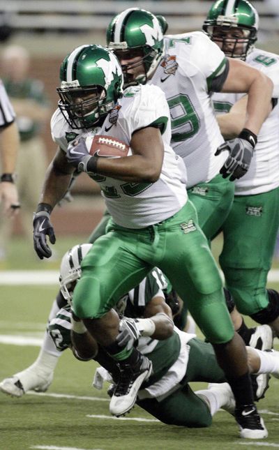 Game MVP Martin Ward of Marshall rushes 12 yards for a touchdown in the first quarter.  (Associated Press)