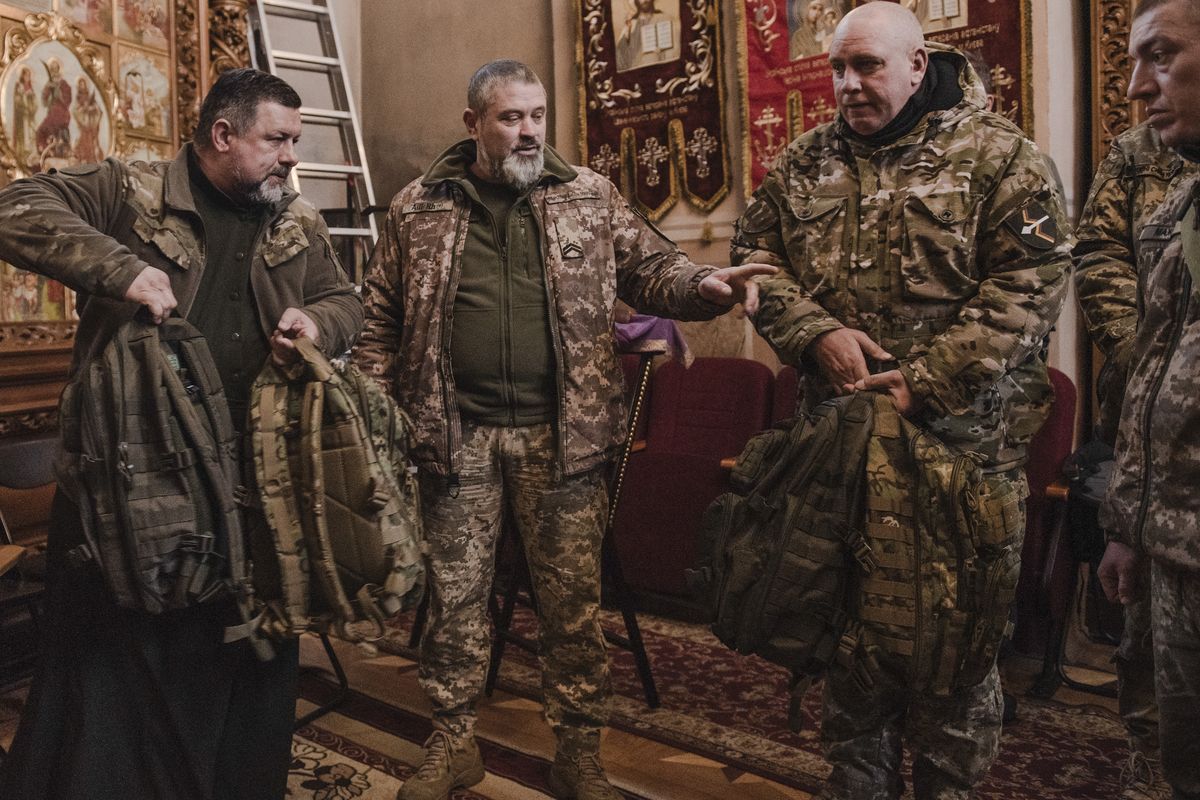 Soldiers distribute supplies on the day of a government eviction at the Kyiv-Pechersk Lavra monastery in Kyiv, March 29, 2023. Ukraine says it will use legal means to remove the pro-Russian monks from the revered Orthodox site.    (Laetitia Vancon/The New York Times)