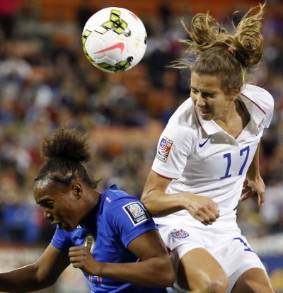 Tobin Heath of the U.S. rises above Haiti’s Samantha Brand to head ball in 6-0 U.S. win. (Associated Press)