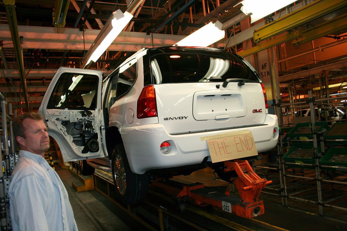In this picture provided by GM worker Kim Clay, an unidentified employee watches as the last sport utility vehicle, a GMC Envoy, rolls down the assembly line the GM Moraine Assembly plant Tuesday during the final shift at the plant. (Kim Clay / The Spokesman-Review)