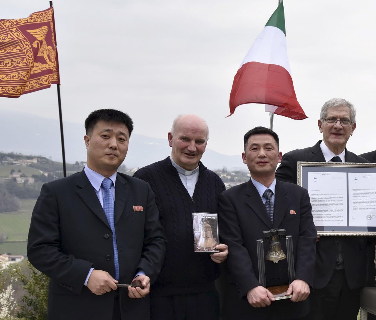 This March 20, 2018 photo made available Thursday, Jan. 3, 2019, by the Parish of Farra di Soligo, shows North Korea’s acting ambassador to Italy Jo Song Gil, second from right, holding a model of “Bell of Peace of Rovereto” during a cultural event on the occasion of a visit of the North Korean delegation to the Veneto region, in San Pietro di Feletto, near Treviso, northern Italy. Jo  went into hiding with his wife in November, South Korea’s spy agency told lawmakers in Seoul on Thursday, Jan. 3, 2019. Jo is flanked by don Brunone De Toffol, parish priest of Farra di Soligo, second from left, and Senator Valentino Perin, right. The North Korean diplomat at left is unidentified. (Aldo-Cietto / Associated Press)