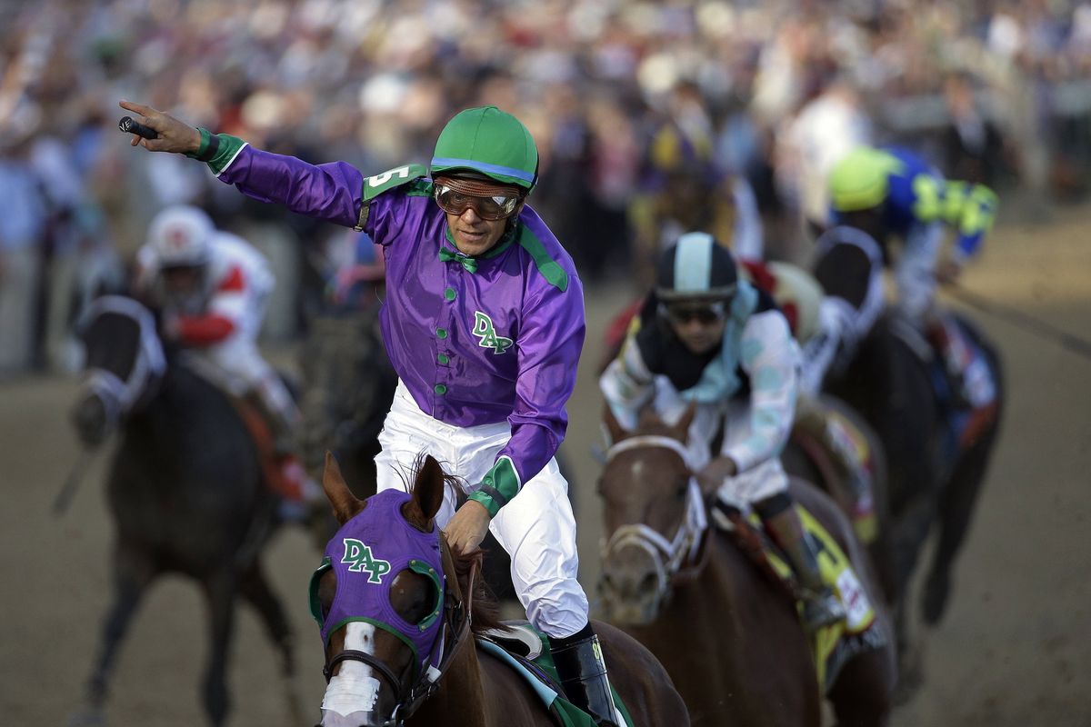 Victor Espinoza rides California Chrome to a victory during the 140th running of the Kentucky Derby at Churchill Downs. (Associated Press)