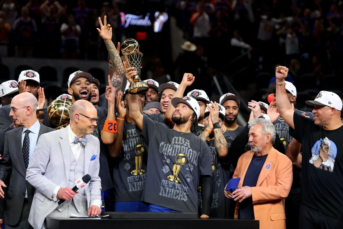 New York guard Jalen Brunson lifts the Bill Russell NBA Finals MVP Award trophy after defeating San Antonio in Game 5 of the 2026 NBA Finals at Frost Bank Center on Saturday in San Antonio. (Getty Images)