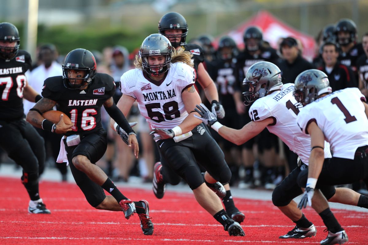 EWU’s Vernon Adams, running the ball against Montana, threw two touchdowns in the last 2½ minutes to give the Eagles a 32-26 win. (Tyler Tjomsland)