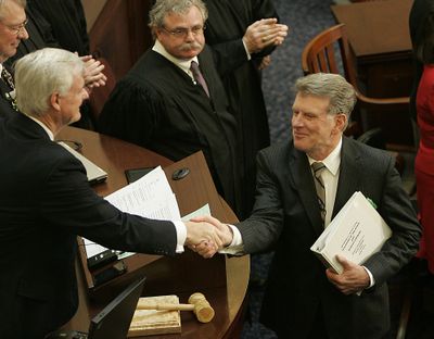 Idaho Gov. Butch Otter visits with delegates before delivering his State of the State address Monday in Boise. (Associated Press)