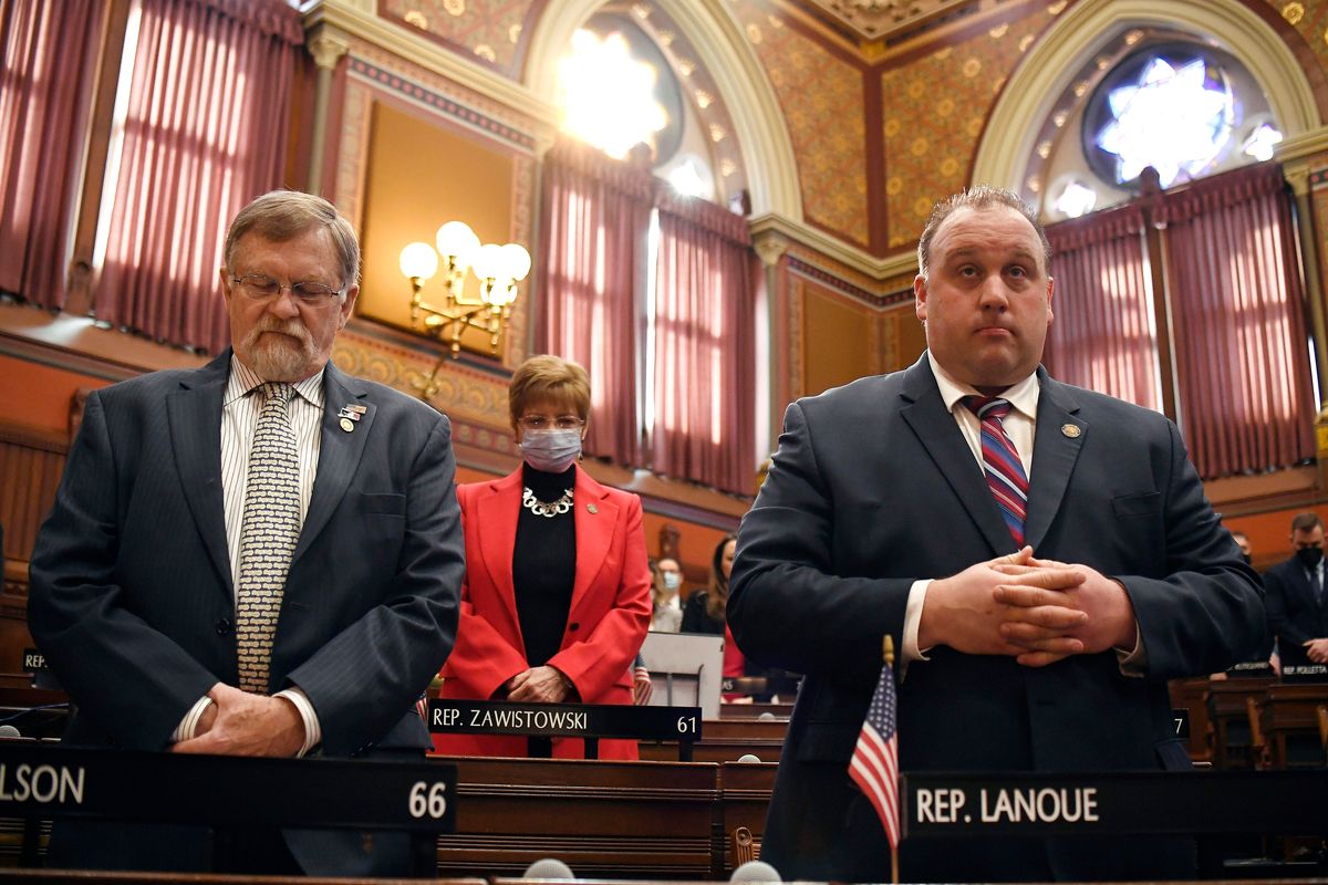 FILE - Connecticut State Rep. David Wilson, R-Litchfield, left, State Rep. Tami Zawistowski, R-East Granby, center, and State Rep. Brian Lanoue, R-Griswold, stand during opening session at the State Capitol, Wednesday, Feb. 9, 2022, in Hartford, Conn. In efforts to raise the salaries of lawmakers, advocates in several states say there needs to be better pay to help improve diversity in statehouse ranks, in terms of race and ethnicity and economic background. Legislative proposals are pending in places including Connecticut and Oregon, states where lawmakers have recently announced they are not seeking re-election to part-time legislatures because they can no longer afford to serve.  (Jessica Hill)