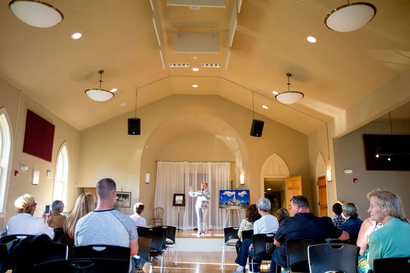 Susan Jacklin, who spearheaded the rennovation of The Jacklin Arts and Cultural Center in Post Falls, speaks to a crowd of more than twenty on Thursday in the center's main room. (Jake Parrish/Coeur d'Alene Press photo)