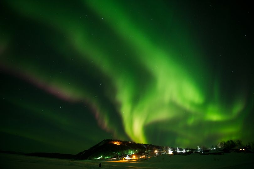 In this Friday, March 9, 2012 photo, an aurora borealis swirls in the sky over the Yukon River village of Ruby, Alaska, a checkpoint of the Iditarod Trail Sled Dog Race. (Marc Lester / Anchorage Daily News)