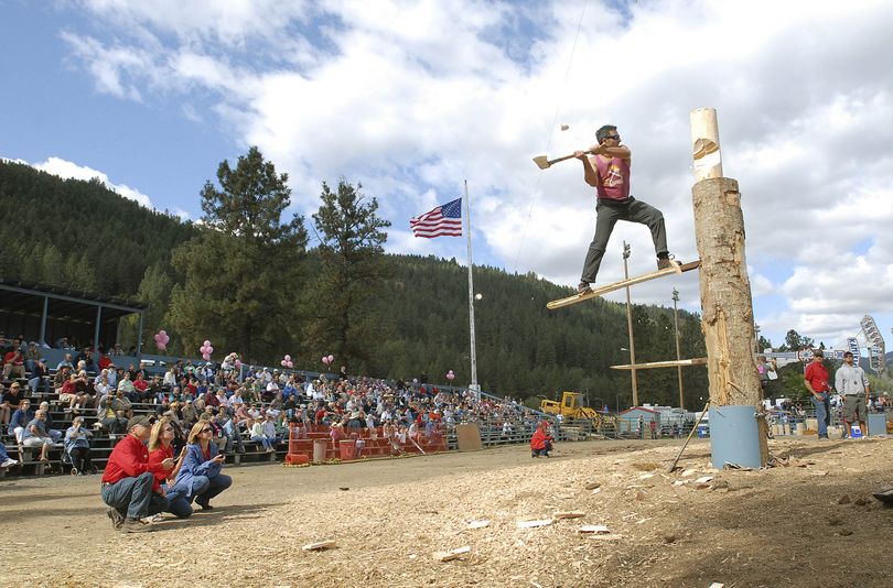 ORG XMIT: IDLEW101 Judges, left, keep watch on the vertical chop event action by Rob Waibel of West Linn, Ore., during the Lumberjack Days competition at Orofino, Idaho, Sunday, Sept. 20, 2009. (AP Photo/Lewiston Tribune, Barry Kough) (Barry Kough / The Spokesman-Review)