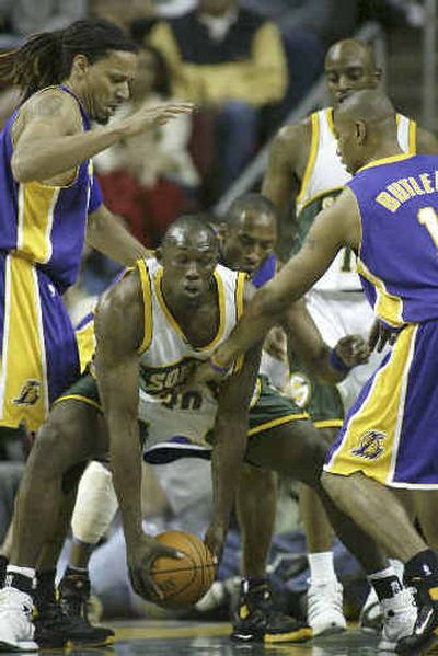 
Seattle's Reggie Evans grabs a loose ball among three Lakers. 
 (Associated Press / The Spokesman-Review)