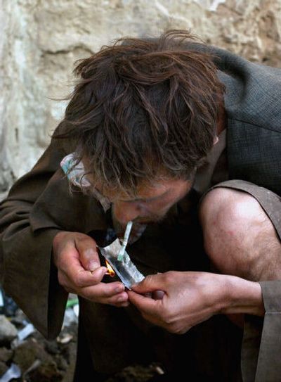 
A man only identified as Shari smokes heroin in Kabul, Afghanistan, on Saturday. Afghanistan could be 