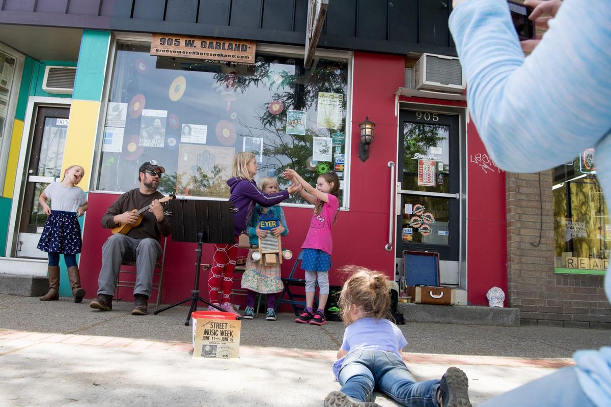 Carey Eyer, second left, performs music with his daughters Neilia Eyer, 9, purple, and Ivy Eyer, 7, blue, and their Garfield Elementary classmates Carmen Walter, 9, white at left, and Jocelyn Hollingsworth, 7, pink at right on Tuesday in Spokane during Street Music Week. (Tyler Tjomsland / The Spokesman-Review)