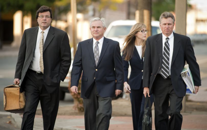 Karl F. Thompson Jr., center, a Spokane police officer facing charges of lying to investigators and using excessive force in the Otto Zehm case, arrives with his legal team at the William O. Douglas Federal Building on Wednesday in Yakima. (Colin Mulvany)