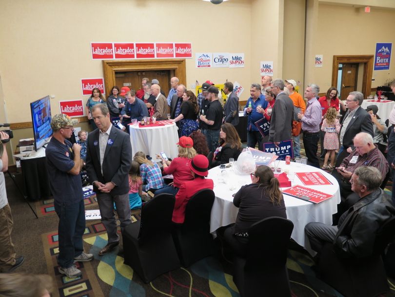 Much of the remaining crowd at the Idaho GOP election-night watch party in Boise gathers around a TV around midnight. (Betsy Z. Russell)