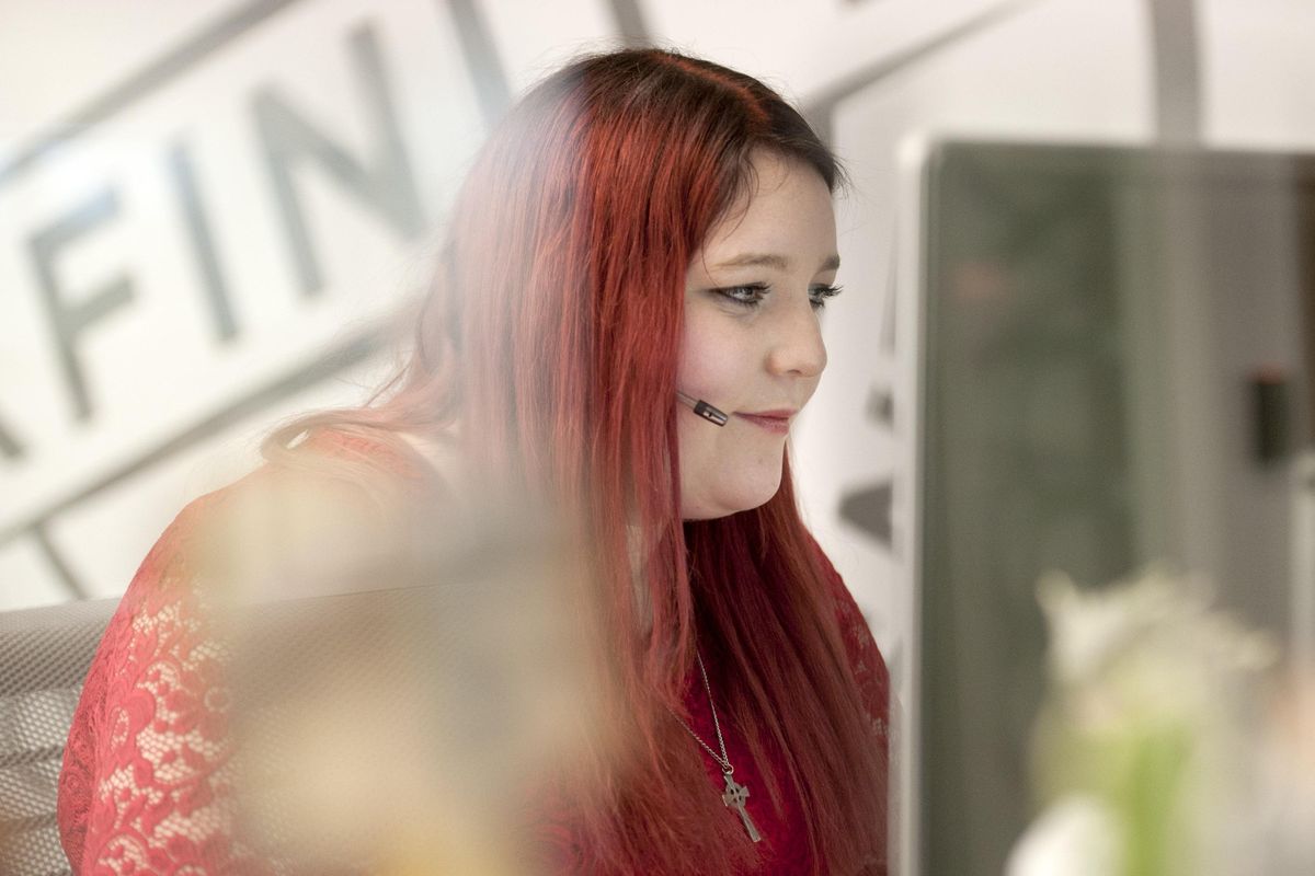 Christine Bowles, an agent at Comcast’s Accessibility Center of Excellence in Liberty Lake, talks with a customer on Wednesday, Jan. 9, 2019. She works in the unit that specializes in taking calls from elderly customers and people with speech impairment who use keyboards to communicate. (Kathy Plonka / The Spokesman-Review)