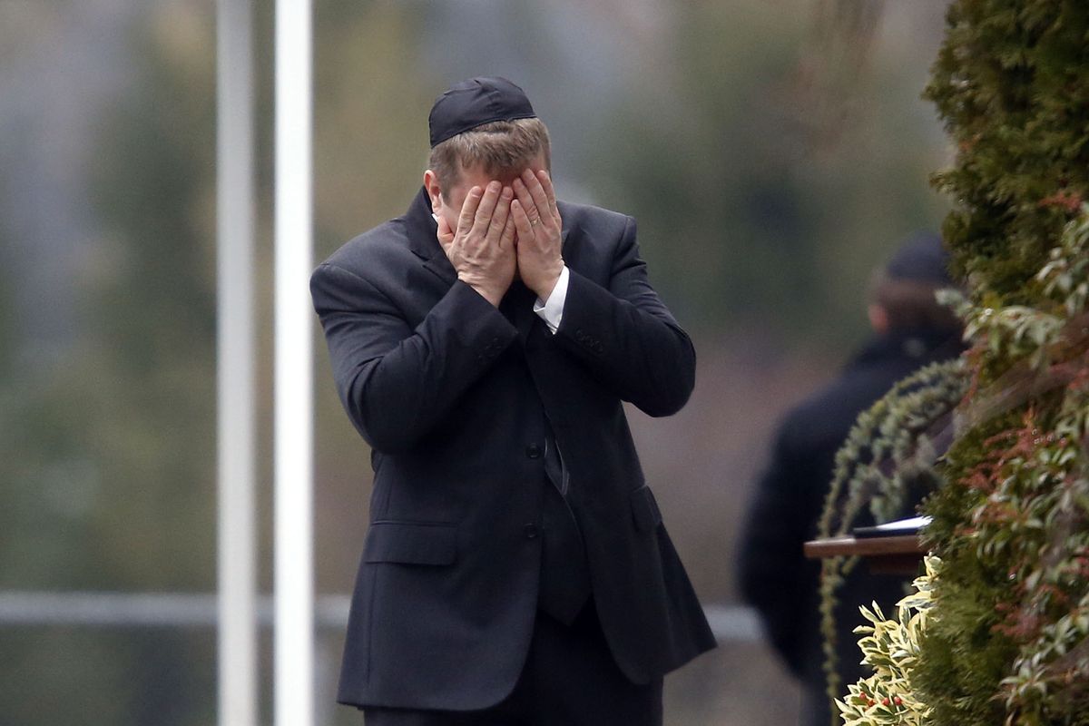 A mourner arrives at the funeral service for 6-year-old Noah Pozner, Monday, Dec. 17, 2012, in Fairfield, Conn. Pozner was killed when a gunman walked into Sandy Hook Elementary School in Newtown Friday and opened fire, killing 26 people, including 20 children. (Jason Decrow / Fr103966 Ap)