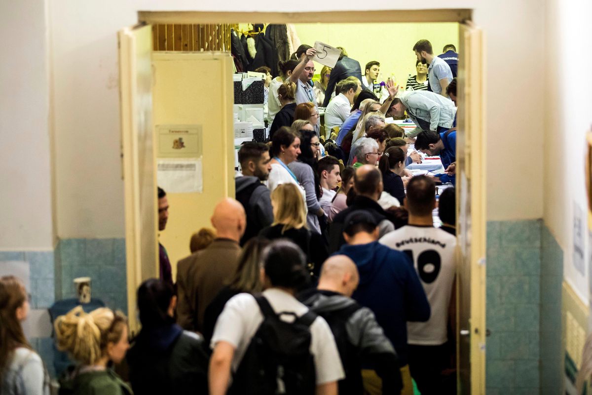 People queue to cast their vote at a polling station, after the official closing time, during general elections in central Budapest, Hungary, Sunday, April 8, 2018. (Balazs Mohai / Associated Press)