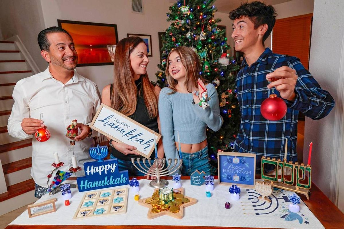 Frank Robleto Jr. and Sarah Robleto have different religious backgrounds (Frank is Catholic and Sarah is Jewish) so they celebrate both Christmas and Hanukkah with their children, Madelyne Robleto, 13, and Jacob Robleto, 19, at their home in Cutler Bay. (AL DIAZ/Miami Herald/TNS)