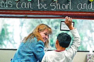 
Linda Cooper, of the Writers-in-Residence Project, works with Longfellow Elementary School student Ramon Mincitar on his poetry Wednesday.
 (Photo by DAN PELLE / The Spokesman-Review)