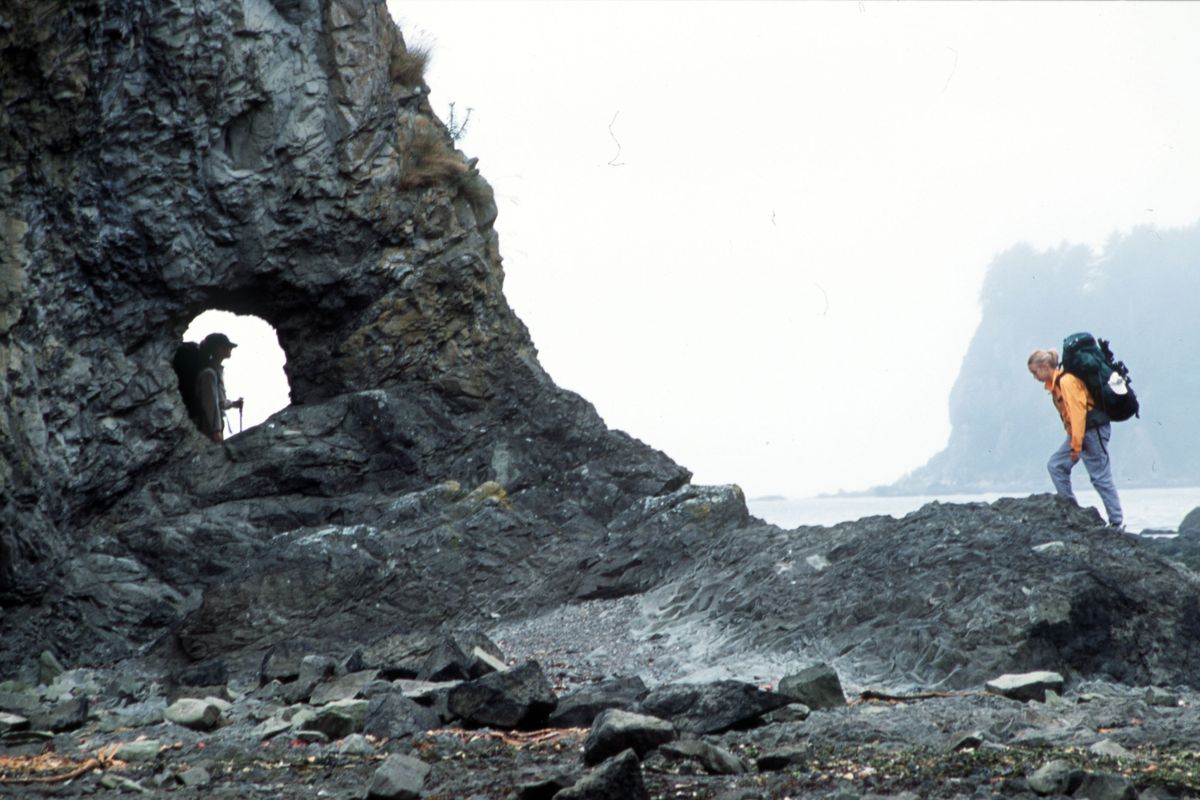 Backpackers west of Lake Ozette explore a stretch of the Olympic Wilderness beaches.