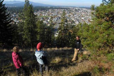 
Coeur d'Alene Parks trail coordinator Monte McCully, right, talks with Waltraut Johnson, left, and Pam Waller on Saturday about the future of a new park on the side of Canfield Mountain. The forested parcel is owned by the city of Coeur d'Alene and will be protected as a natural hiking area. 
 (Photos by JESSE TINSLEY / The Spokesman-Review)