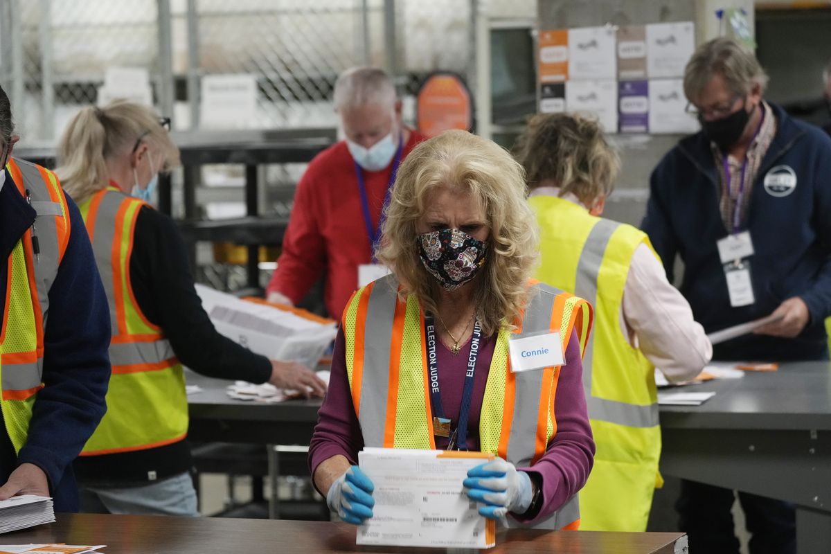 Election judges process early ballots in the Jefferson County elections division, Tuesday, Oct. 26, 2021, in Golden, Colo. The first major election day following a year of relentless attacks on voting rights and election officials went off largely without a hitch. The relative calm was a relief to those who oversee state and local elections, but election experts say that might not matter to the millions of Americans who now believe in conspiracy theories trumpeting rampant electoral fraud.  (David Zalubowski)