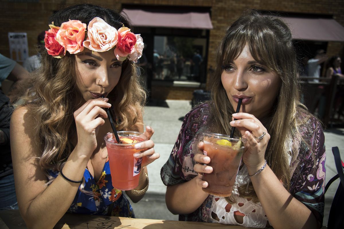 Sunny Chavez,  left, and Amanda Wilponen enjoy drinks while listening to music at Elkfest, Sunday, June 11, 2017, in Spokane’s Browne’s Addition. (Colin Mulvany / The Spokesman-Review)