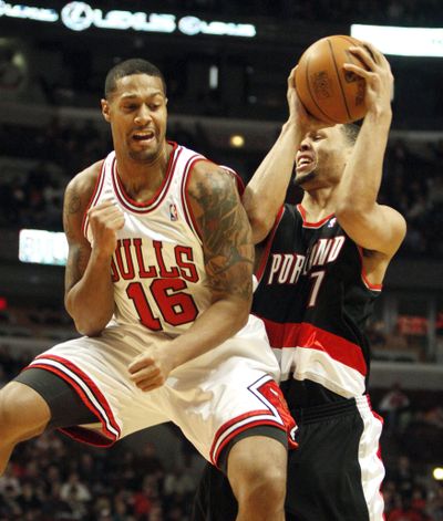 Chicago Bulls’ James Johnson, left, fouls Portland Trail Blazers’ Brandon Roy during the first half of Chicago’s 115-111 OT win.  (Associated Press)