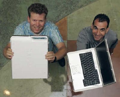
Ken Musgrave, left, and Steve Gluskoter display desktop and laptop models from Dell Computer in Austin, Texas. The BTX desktop series on the left has a side vent to promote cooling and provides a handle. The laptop on the right is the Inspiron 6000. 
 (Associated Press / The Spokesman-Review)
