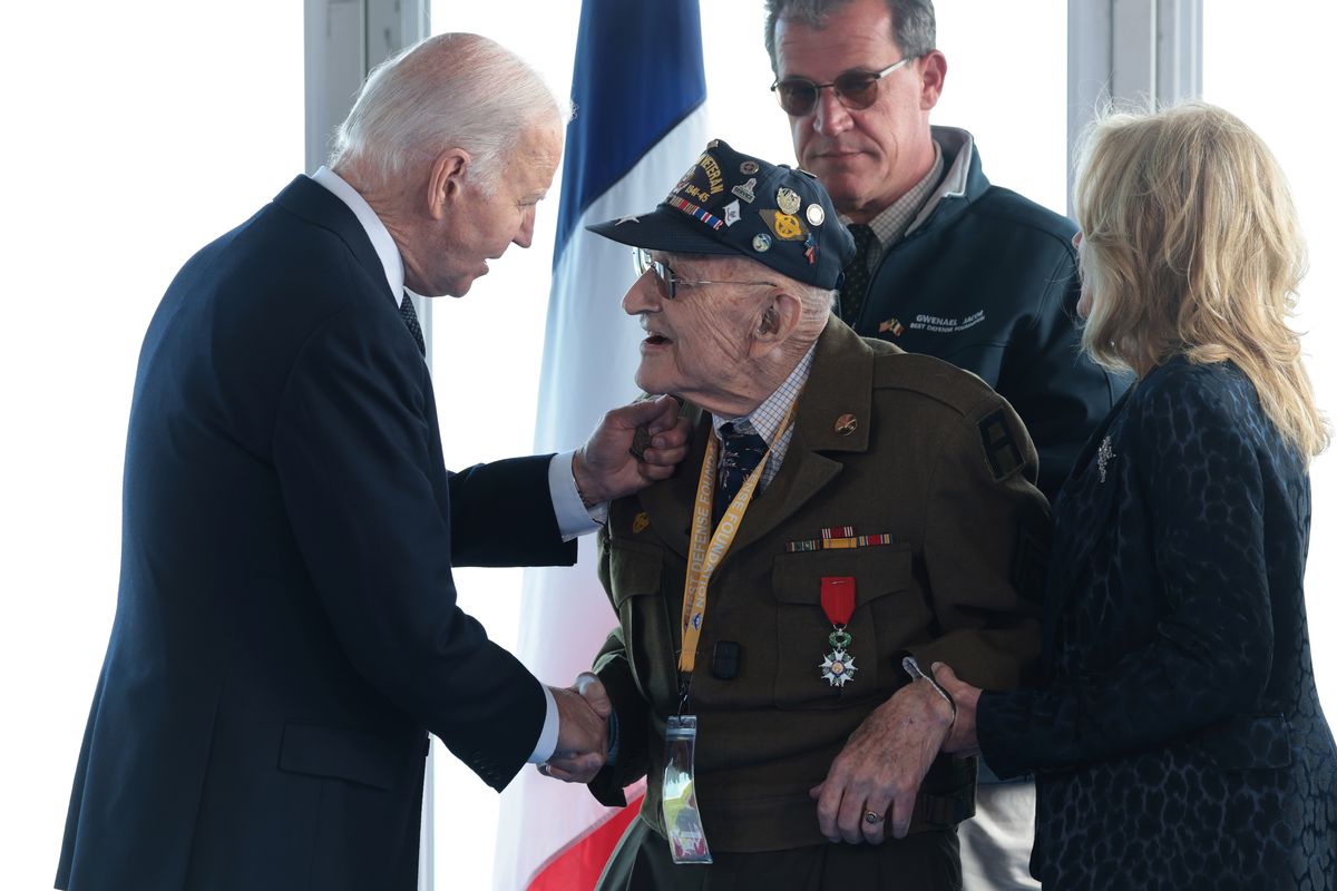 U.S. President Joe Biden, left, and first lady Jill Biden greet American World War II veterans before a ceremony marking the 80th anniversary of D-Day at the Normandy American Cemetery on Thursday in Colleville-sur-Mer, France. Veterans, families, political leaders and military personnel are gathering in Normandy to commemorate D-Day, which paved the way for the Allied victory over Germany in World War II.  (Win McNamee)