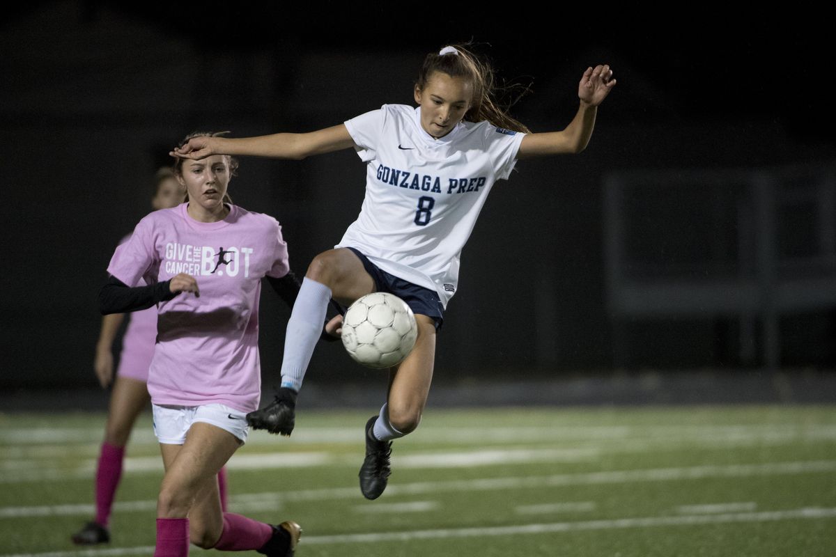 Gonzaga Prep’s Chelsea Le leaps to intercept a ball in front of Mead defender Katie Kuka on Oct. 11, 2017, at Gonzaga Prep. Le was named first-team all-state on Wednesday. (Jesse Tinsley / The Spokesman-Review)