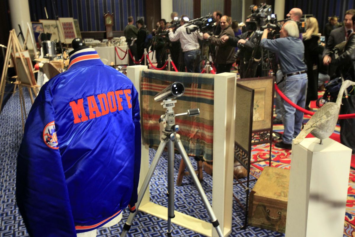 A New York Mets jacket, personalized for Bernard Madoff, is displayed during an auction preview of his seized items in New York on Friday. Almost 200 items seized from the fallen financier’s homes are being sold, including furs, dishes and stationery.  Associated Press photos (Associated Press photos)