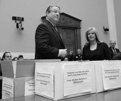 
With boxes full of petitions, former Vice President Al Gore and  his wife, Tipper, arrive at a hearing room on Capitol Hill in Washington on Wednesday to testify on climate change. 
 (Associated Press / The Spokesman-Review)