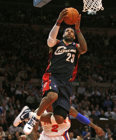 LeBron James goes up for two of his easier points in a 52-point night.  (Associated Press / The Spokesman-Review)