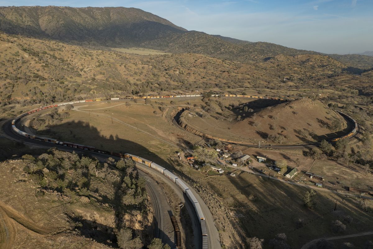 The morning light illuminates the Loop Ranch as a train passes through the Tehachapi railway loop on Sept. 14 in Tehachapi, Calif.  (Tyler Schiffman)