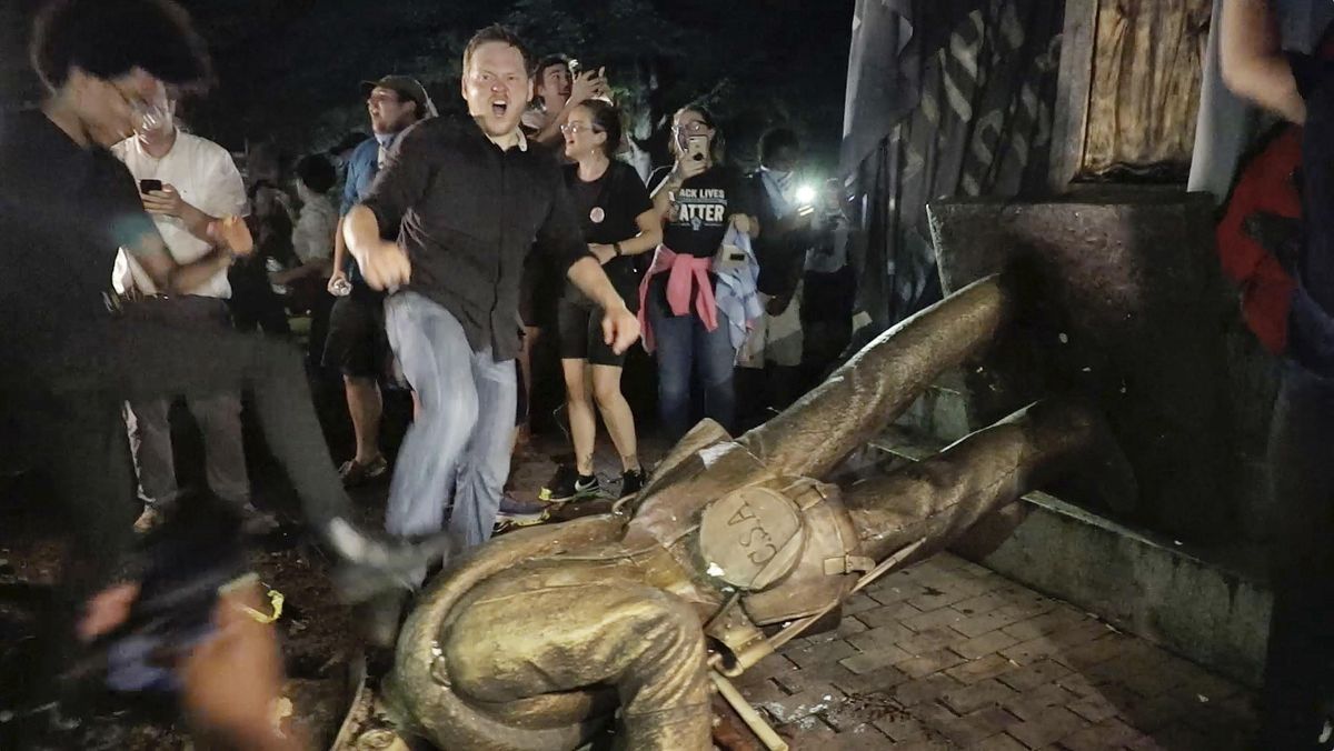 Protesters celebrate after the Confederate statue known as “Silent Sam” was toppled on the campus of the University of North Carolina in Chapel Hill, N.C., Monday, Aug. 20, 2018. (Julia Wall / Associated Press)